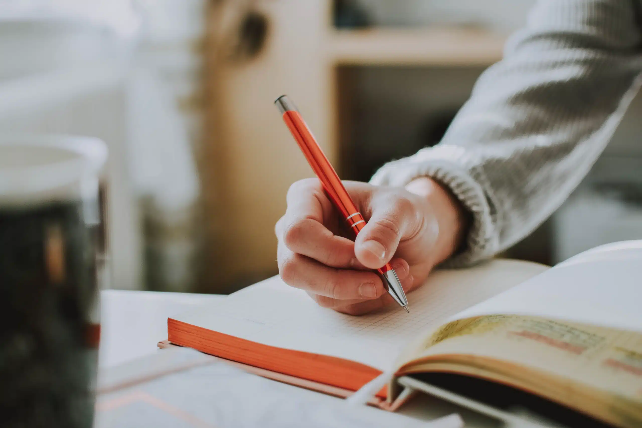 Student intently writing on a notebook.