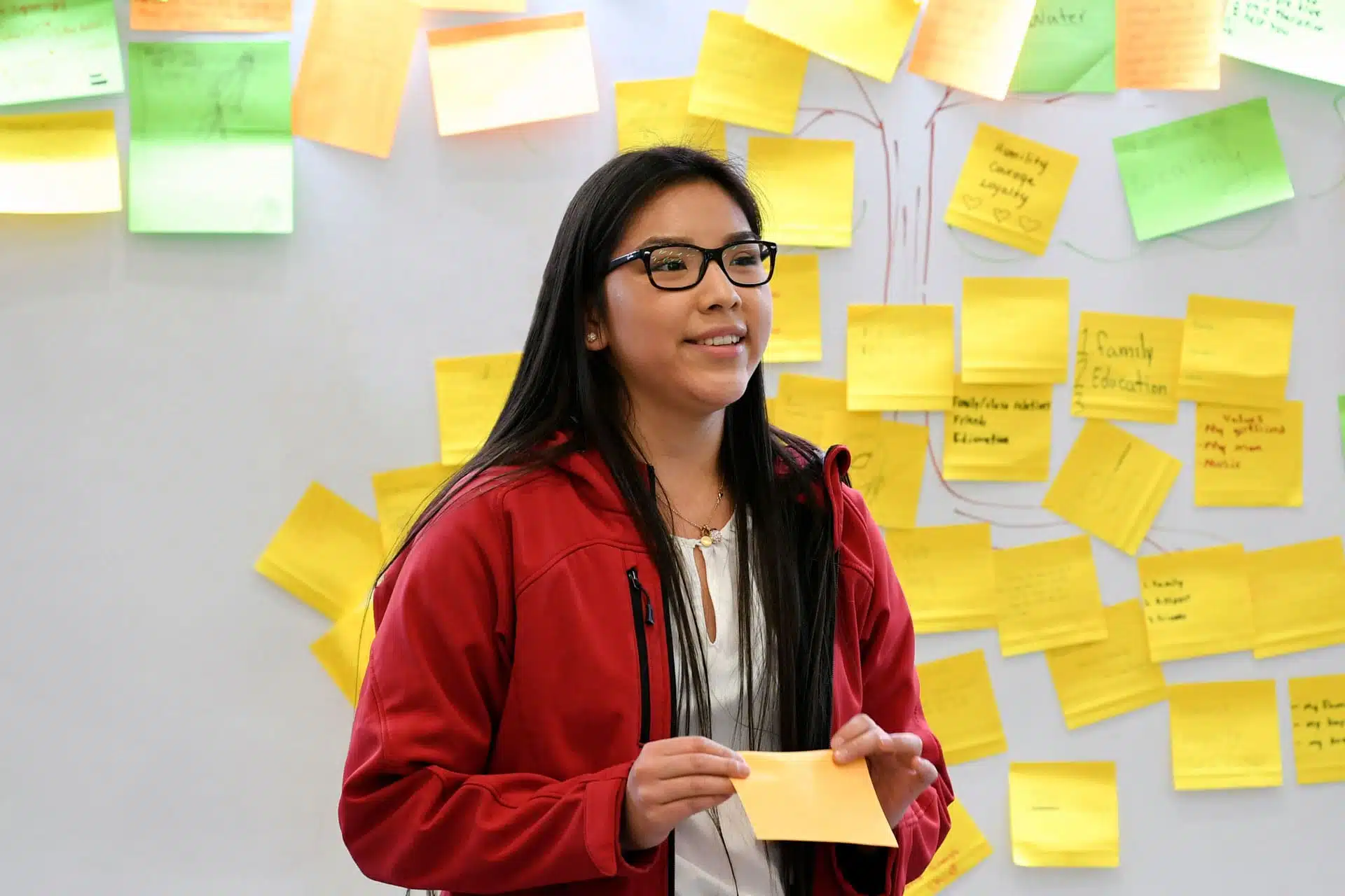 Indigenous student confidently presenting in front of class.