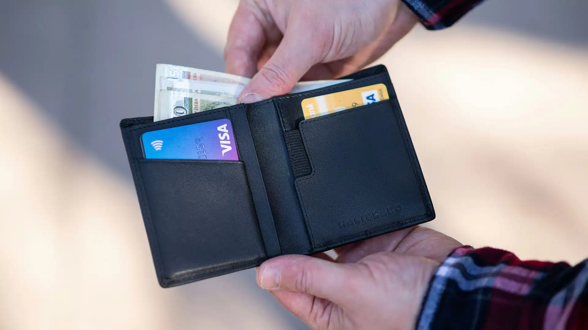 Person taking money out of a wallet.