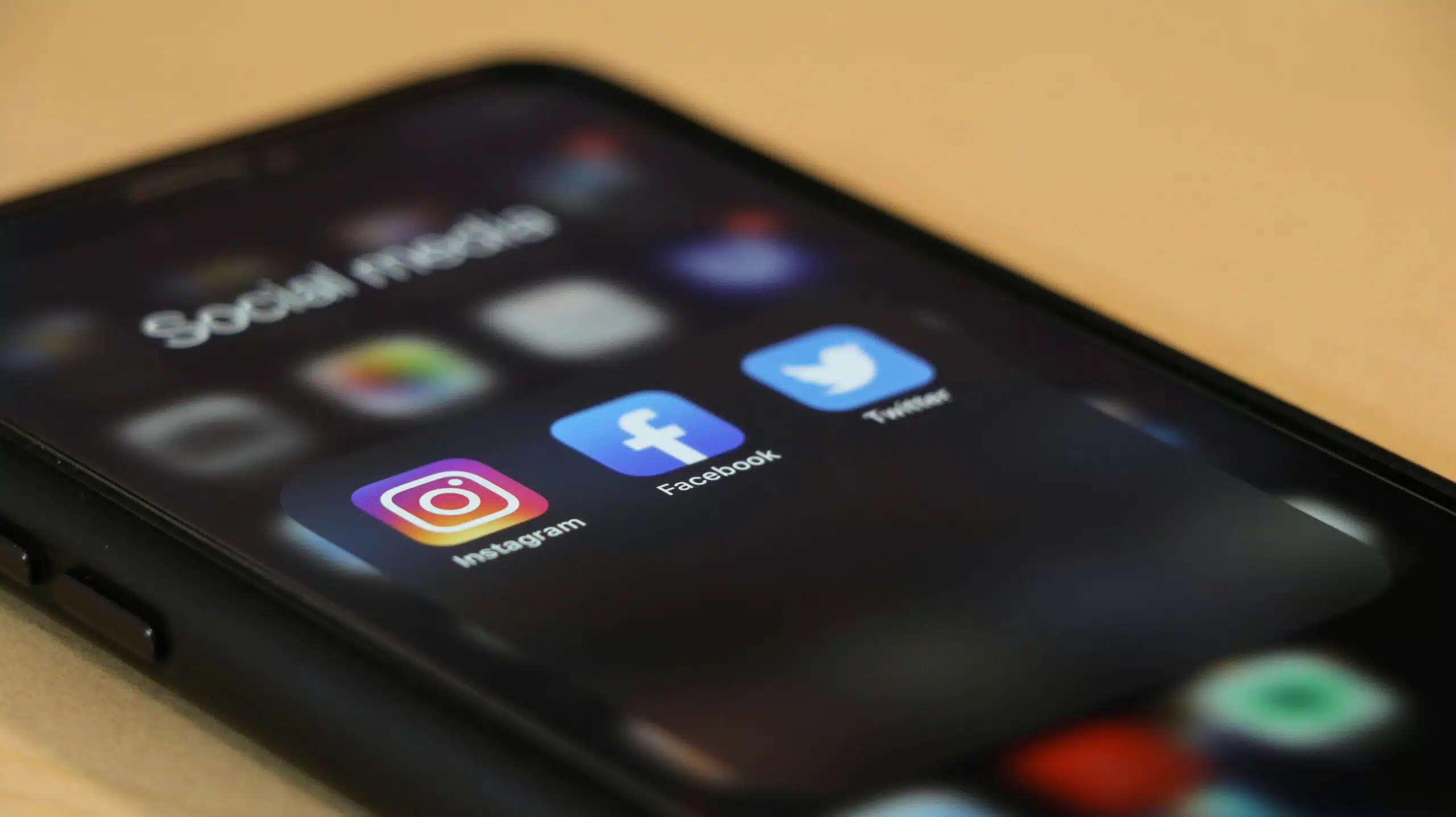 a cellphone with social media apps on screen